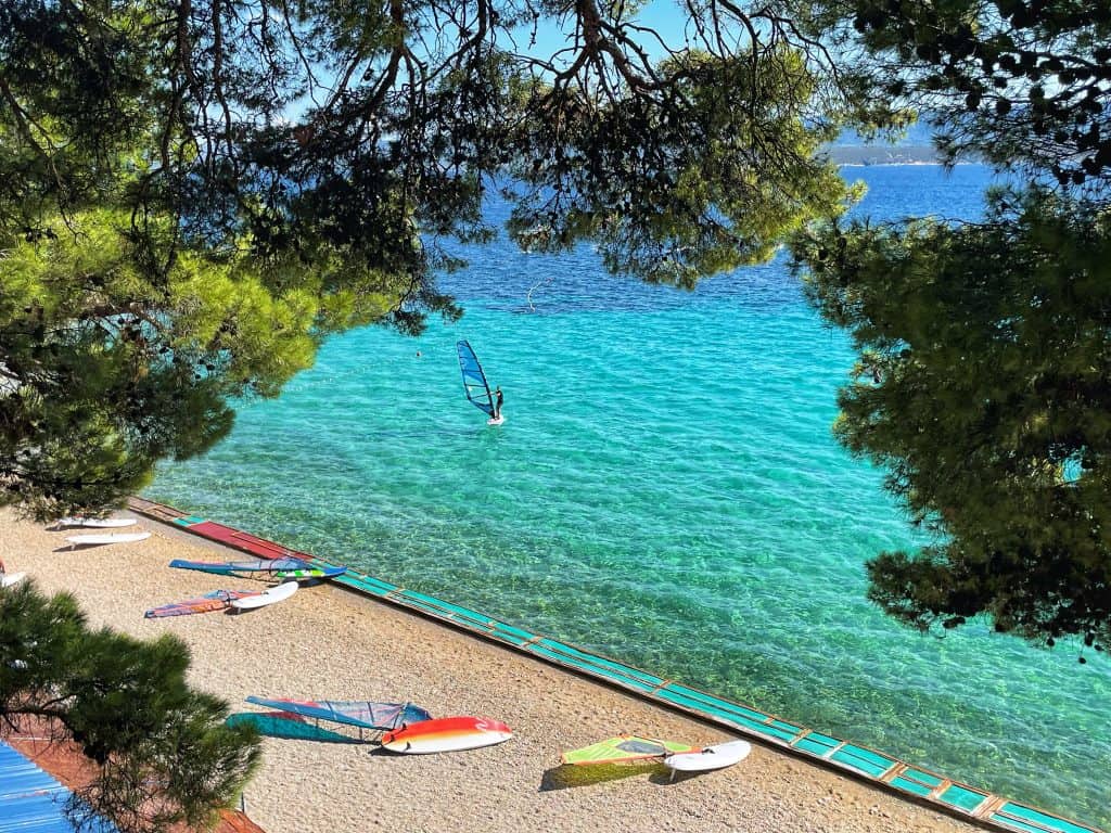 Family holiday in Croatia: Beach in Croatia with windsurfer in the distance