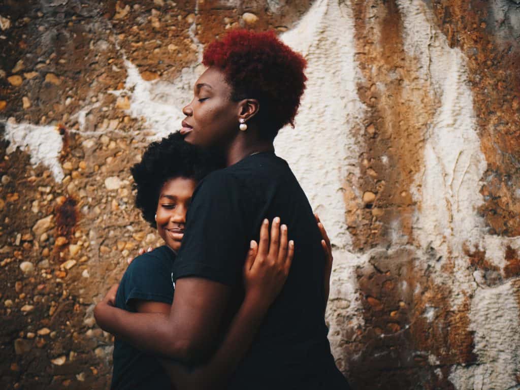 Woman hugging girl
