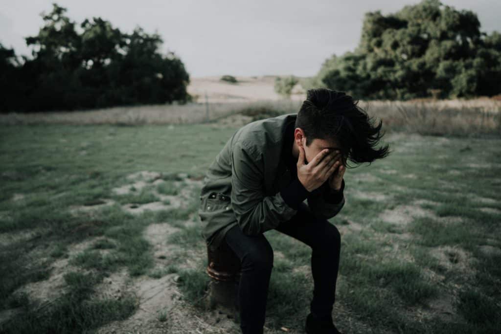Boy with his head in his hands
