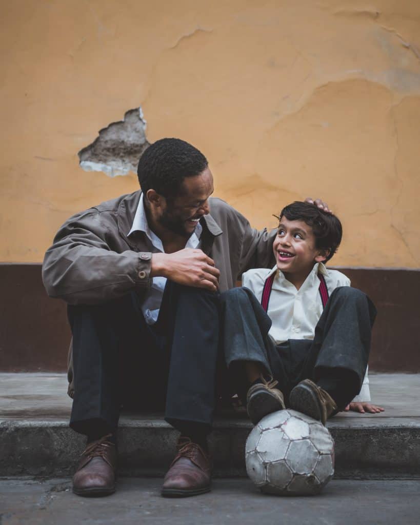 Man talking to boy with a football