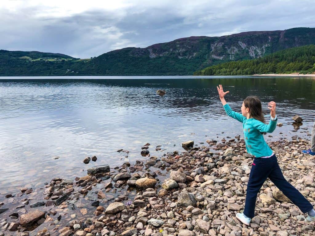 Girl throwing stones in Loch Ness 