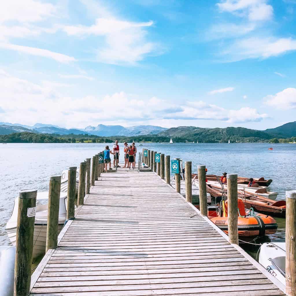 A jetty on a lake with people standing at the end