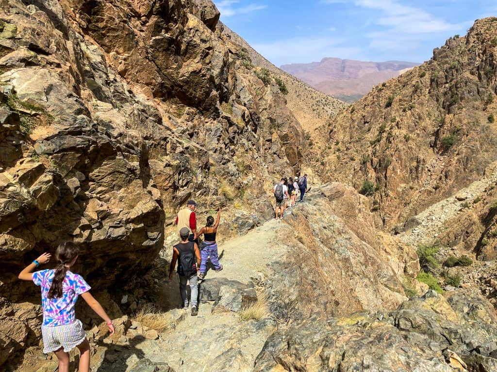People walking down a steep path in the Atlas mountains