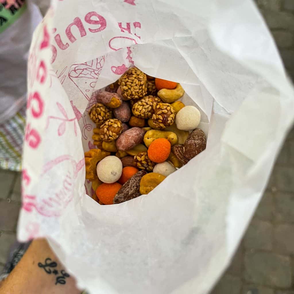 Flavoured nuts in a paper bag