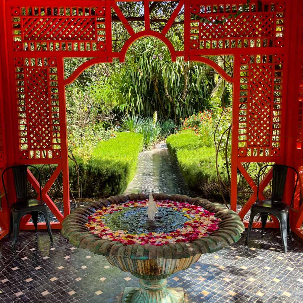 Asian style fountain and pagoda painted in red at Anima Garden