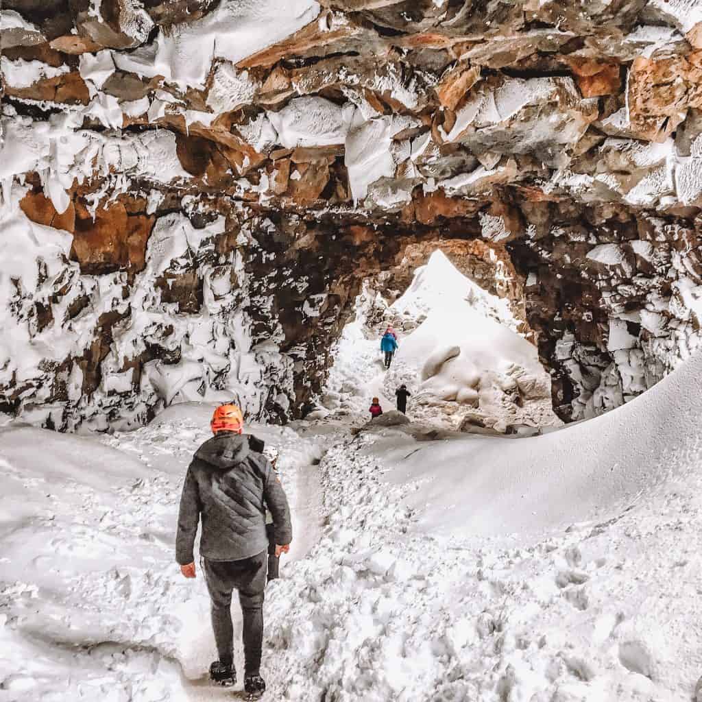 People walking in an ice cave in Iceland