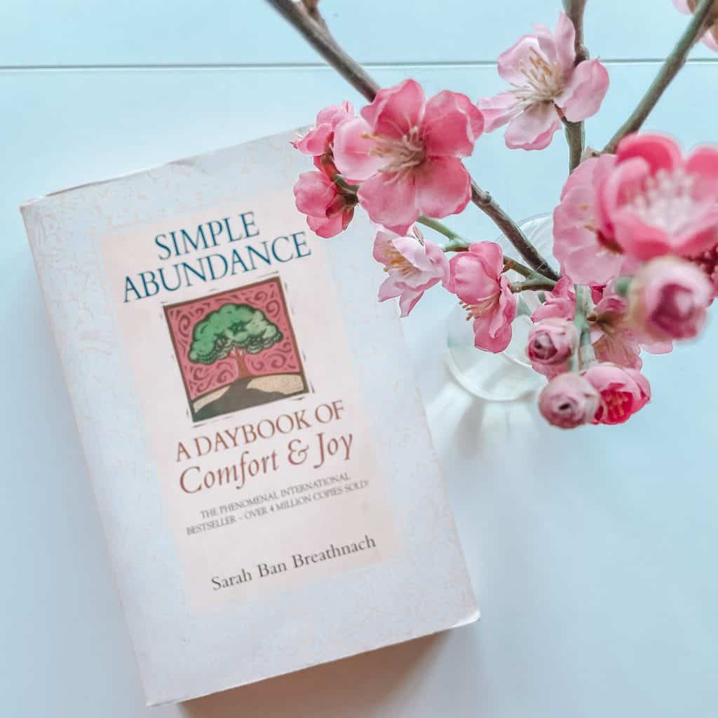 Book Simple Abundance with flowers in the foreground