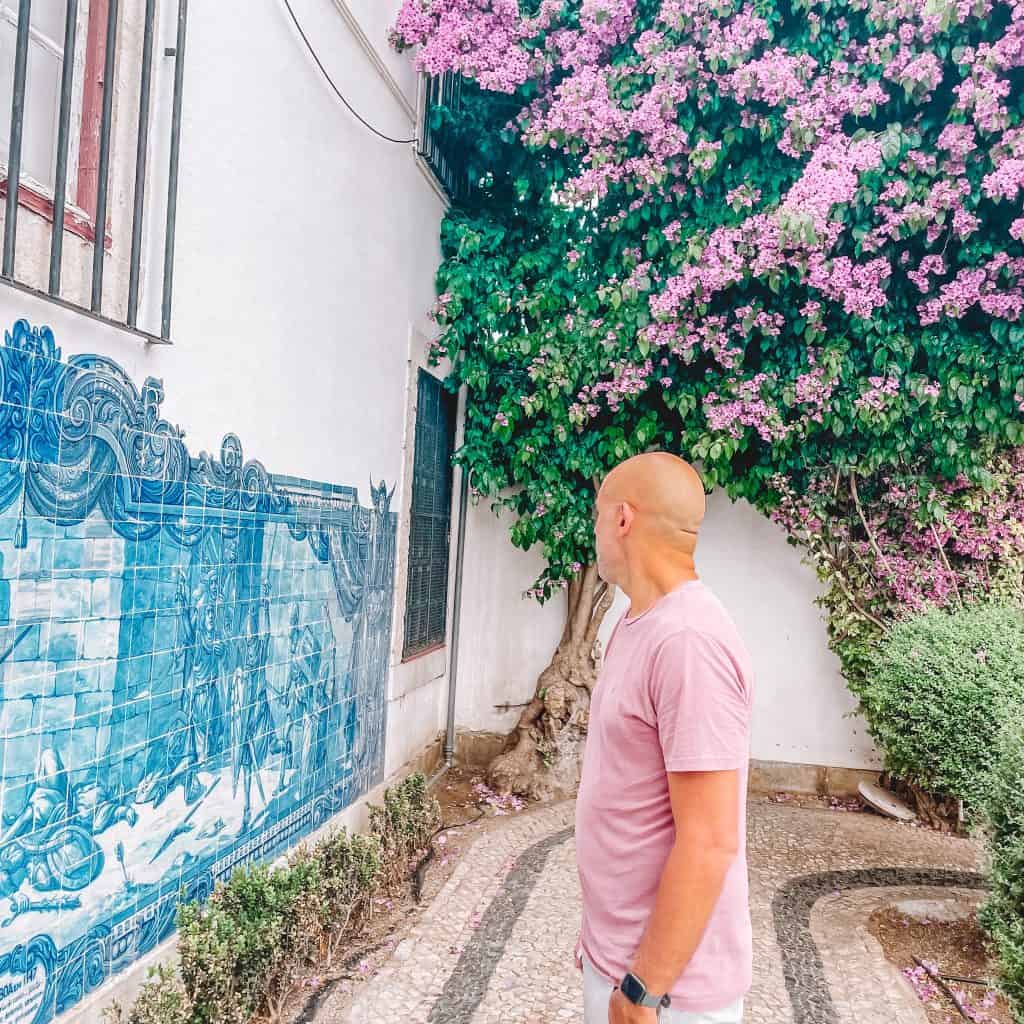 Man looking at tiles at blue and white tiles in Lisbon 