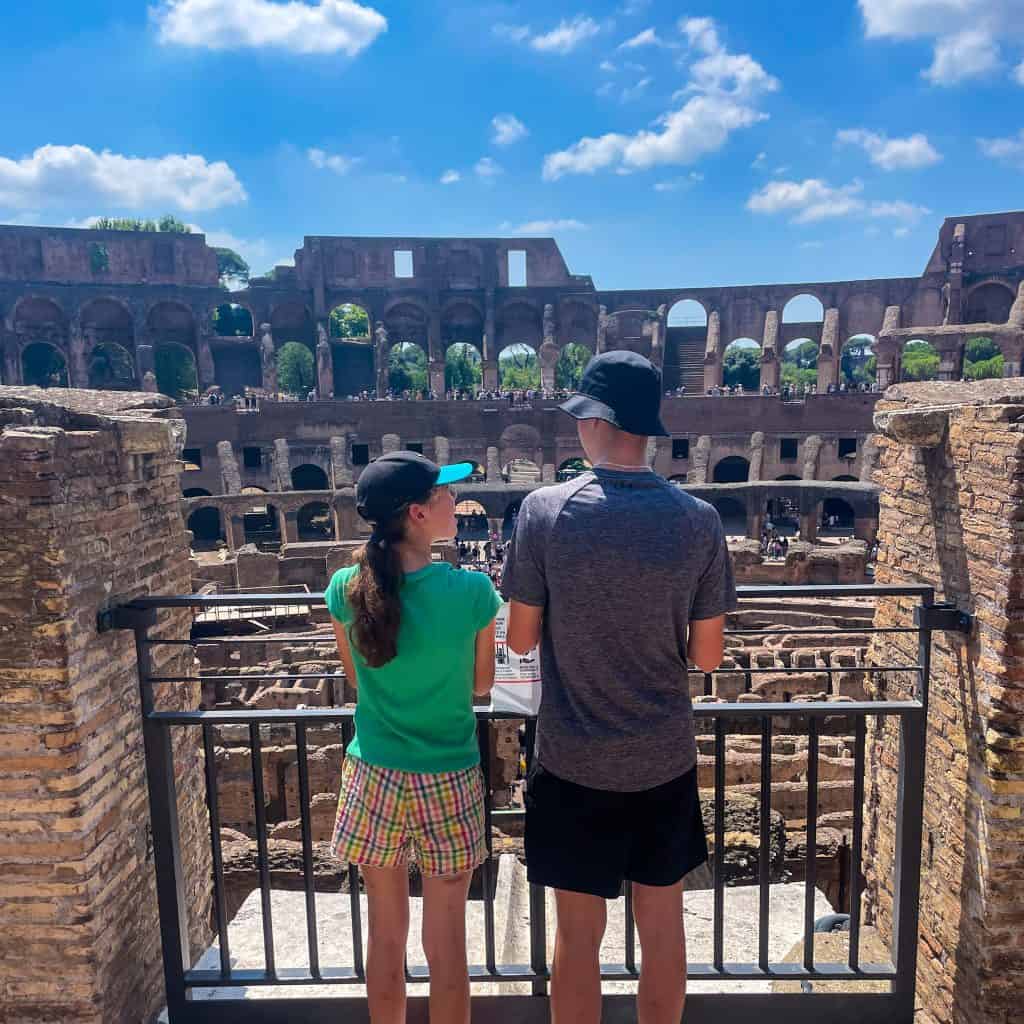Two children looking out at the Colosseum in Rome