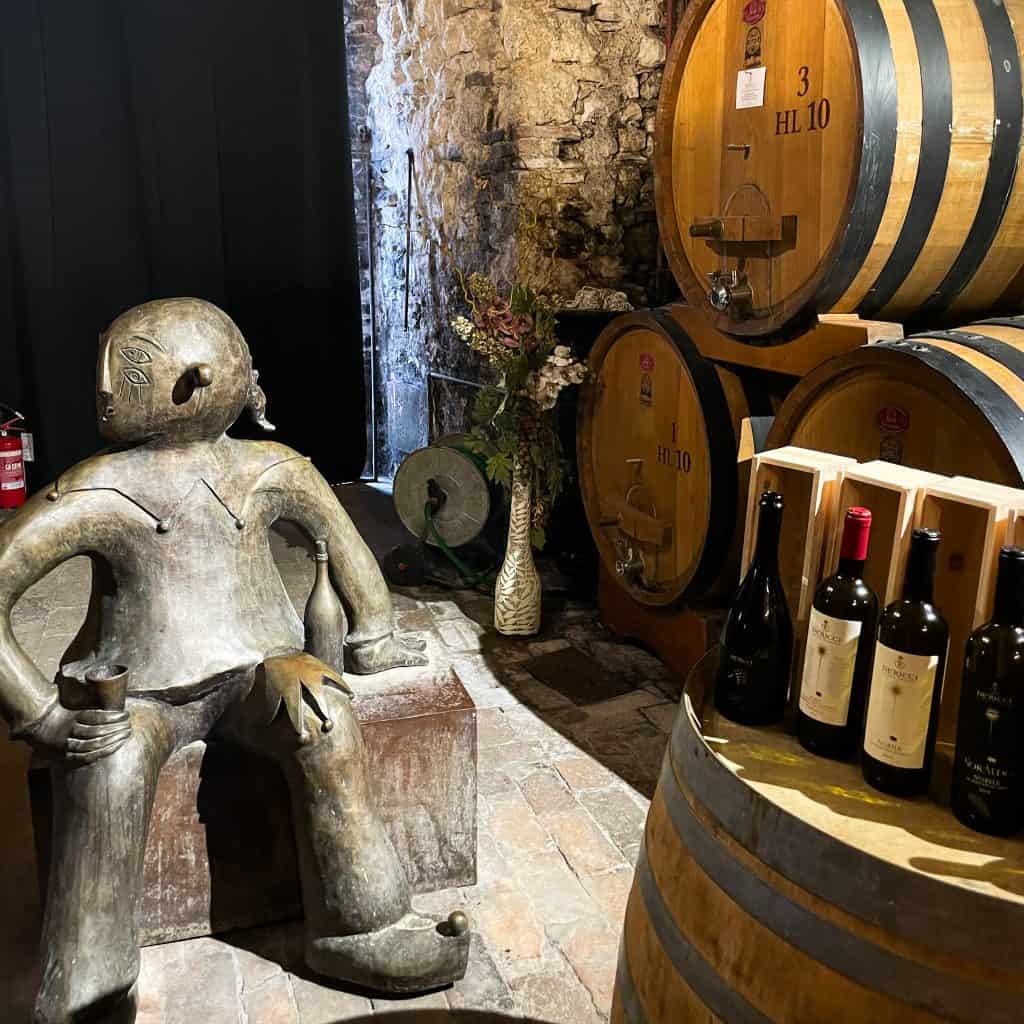 Statue and wine barrels at Cantina De Ricci winery 