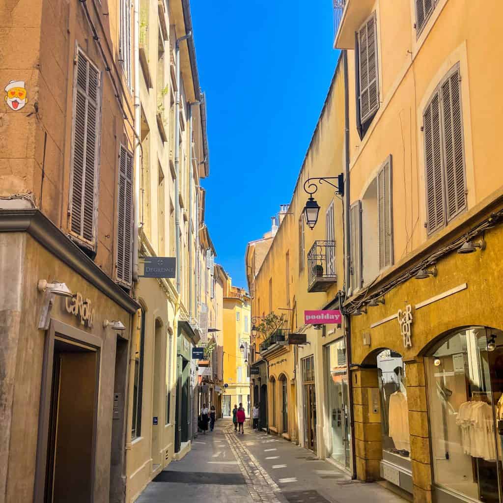 A narrow street with yellow coloured buildings in Aix En Provence
