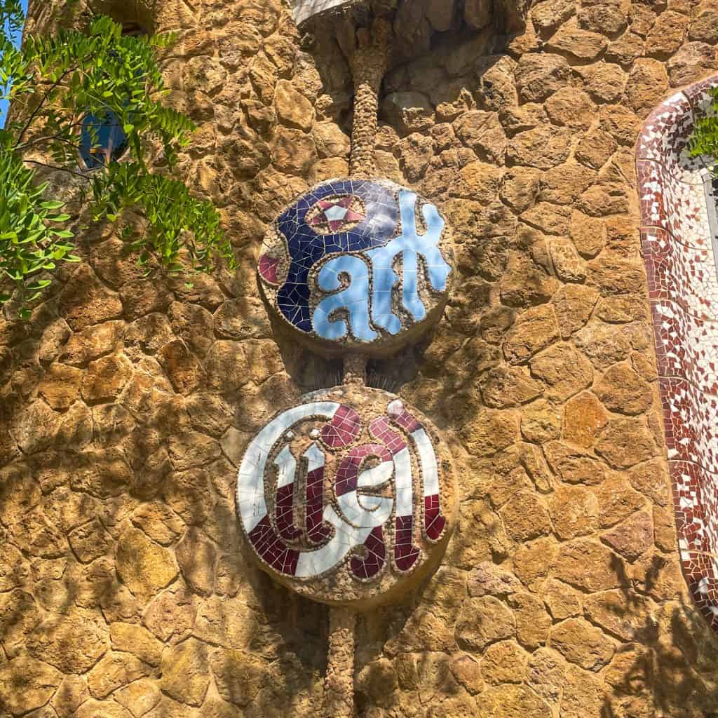 Ceramic tiles spelling out 'Park Guell' at the entrance to Park Guell in Barcelona