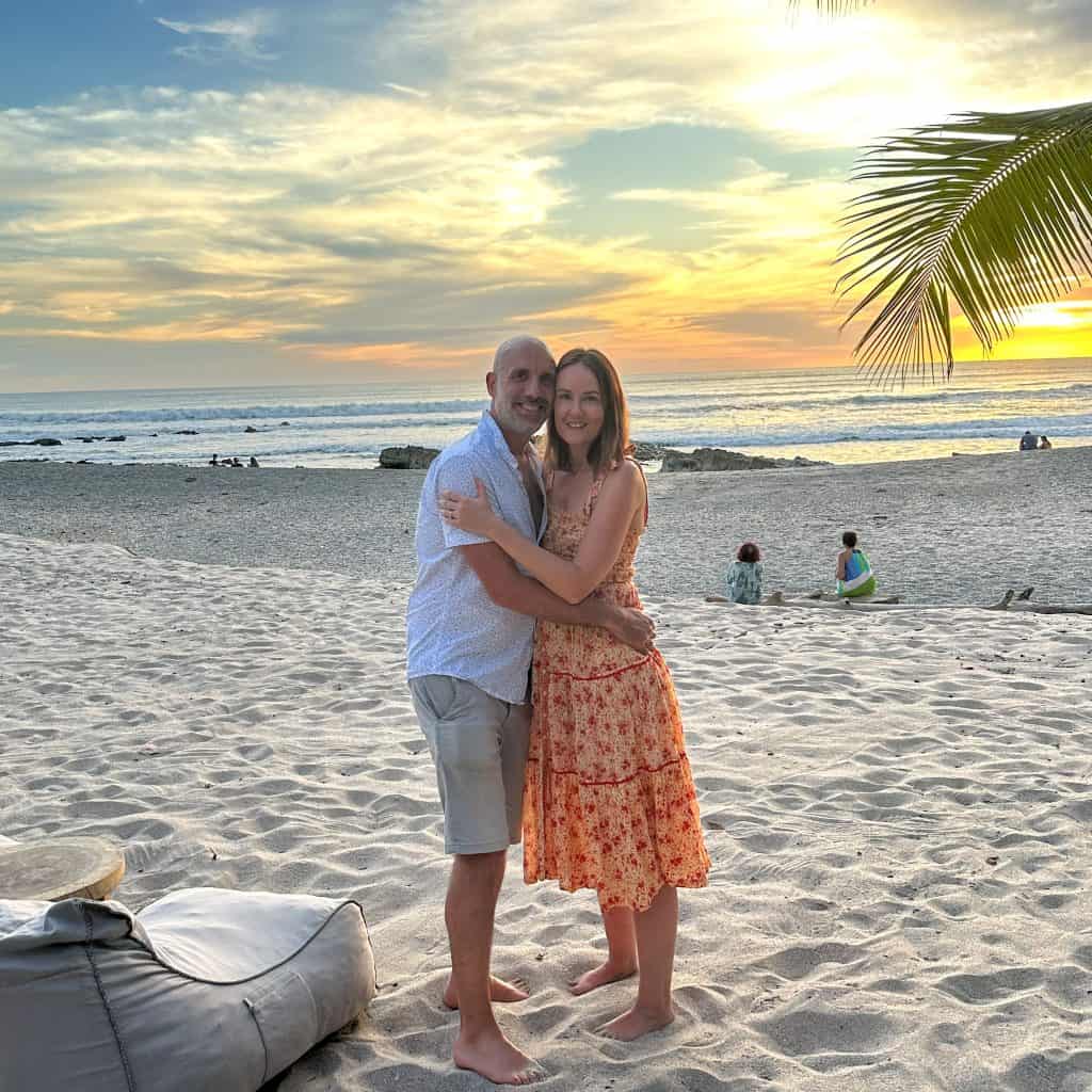 Man and woman on Playa Santa Teresa in Costa Rica at sunset