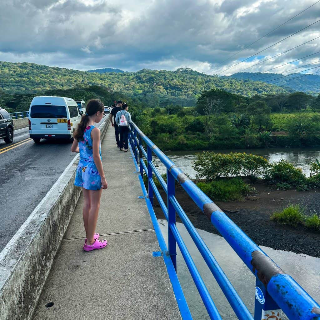 Girl looking over the side of the Tarcoles Bridge in Costa Rica