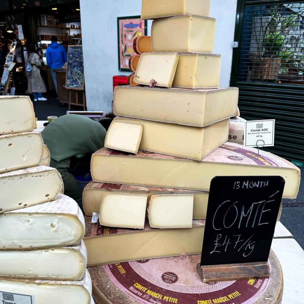 Blocks of cheese piled on top of each other at food market