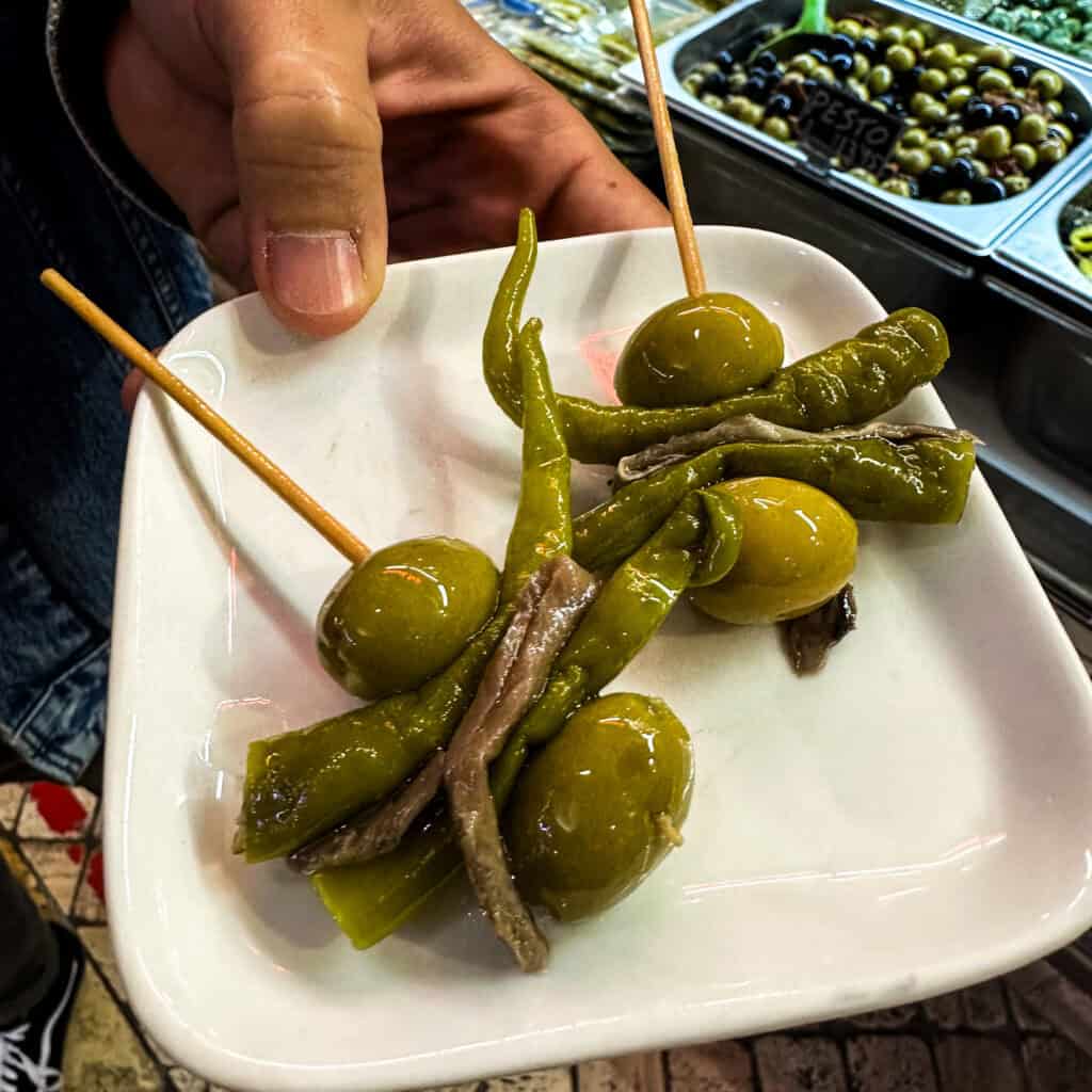 Pintxos snacks - olives, peppers and anchovies on a stick