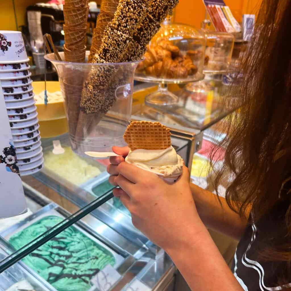 Girl holding an ice cream in an ice cream parlour