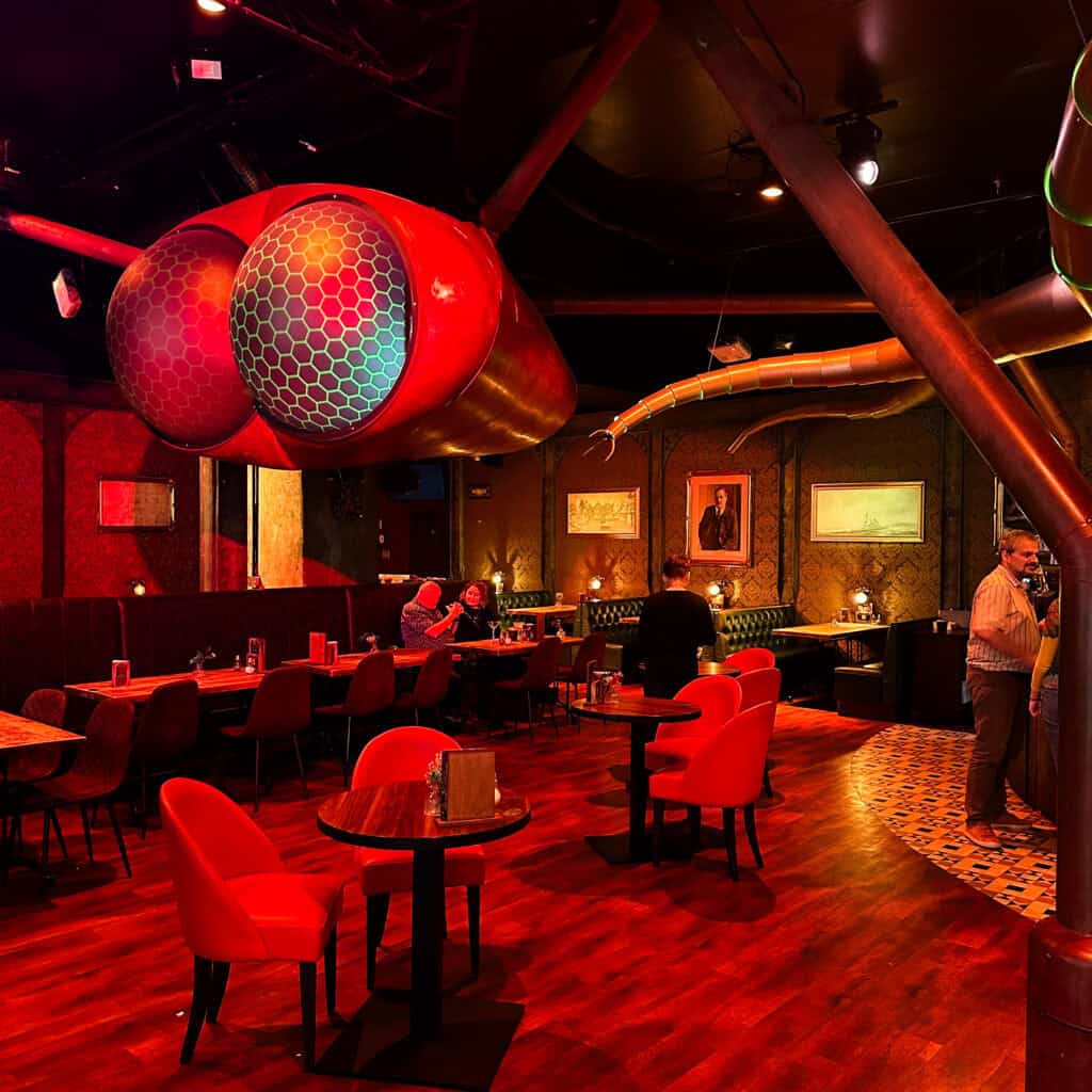 Bar bathed in red light with alien decorations 