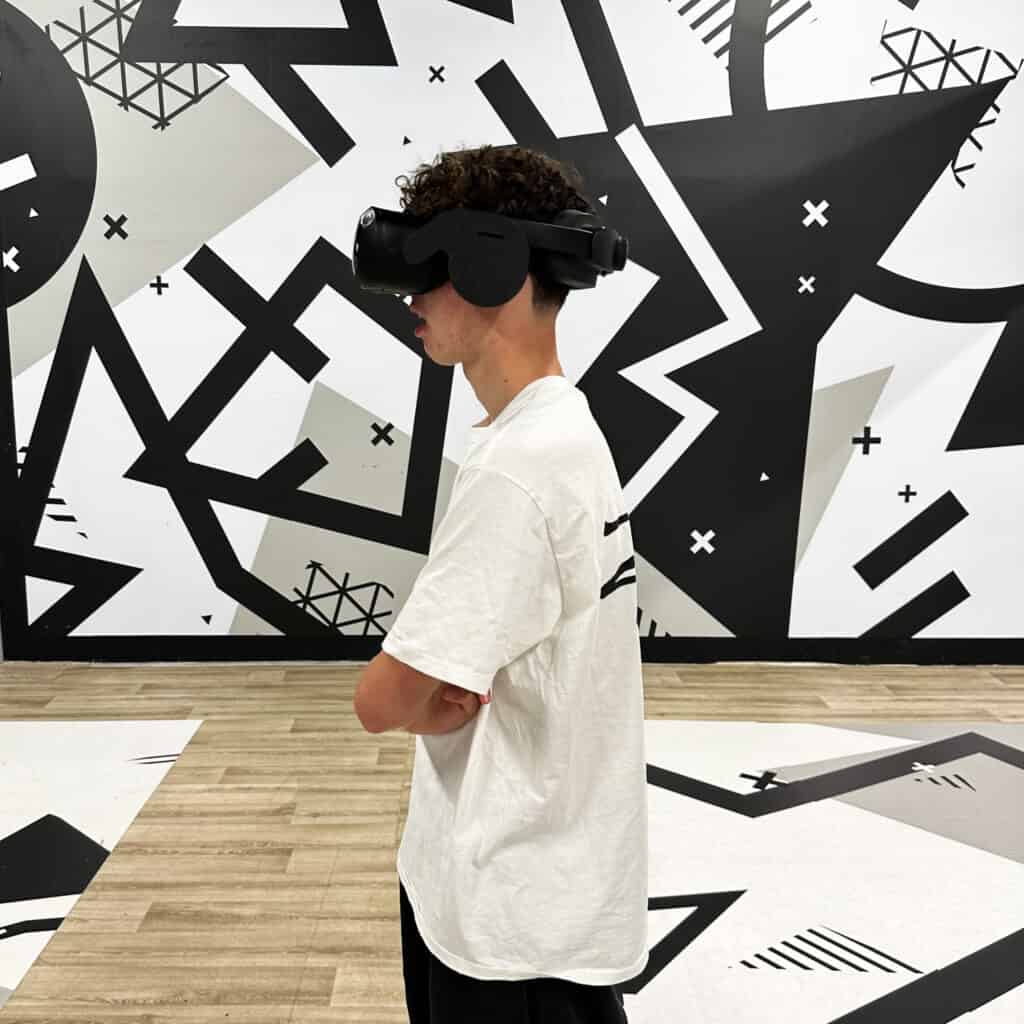 Boy with VR headset on in black adn white room