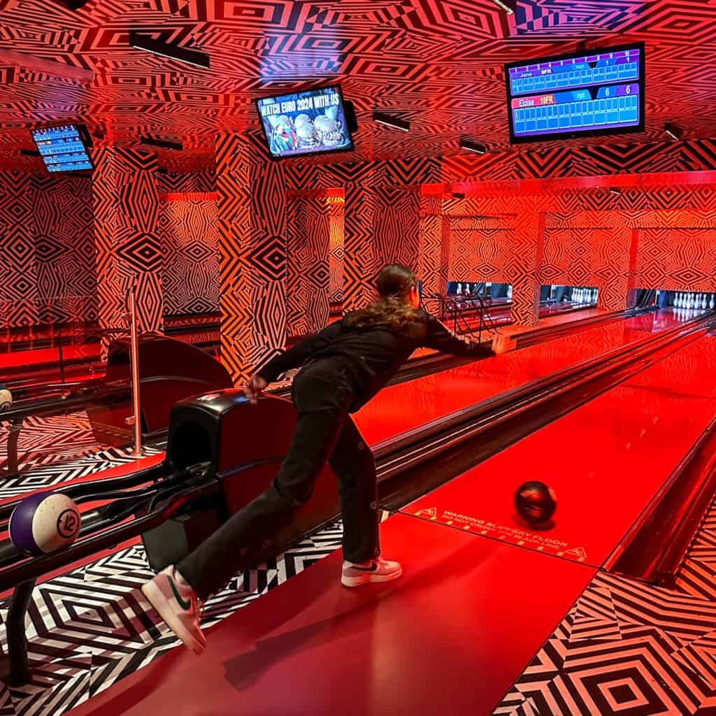 Girl bowling at a bowling alley
