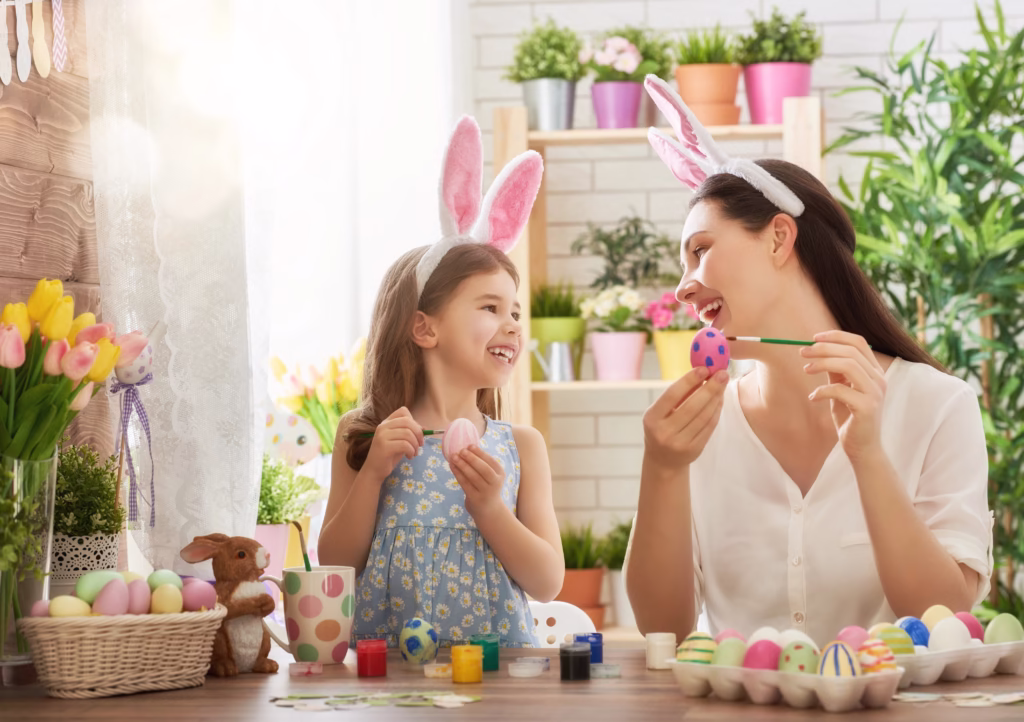 Mother and daughter painting easter eggs