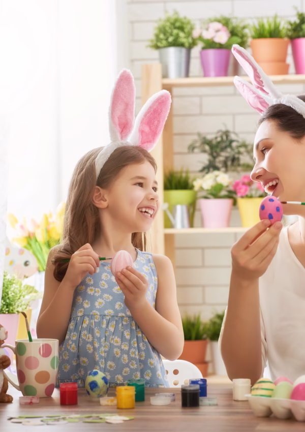 Mother and daughter painting easter eggs